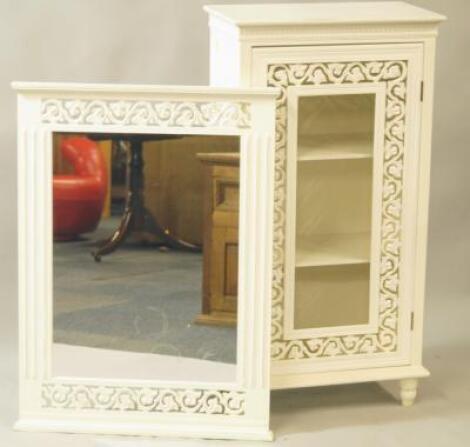 A modern white painted display cabinet and wall mirror