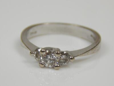 An 18ct white gold three stone diamond ring