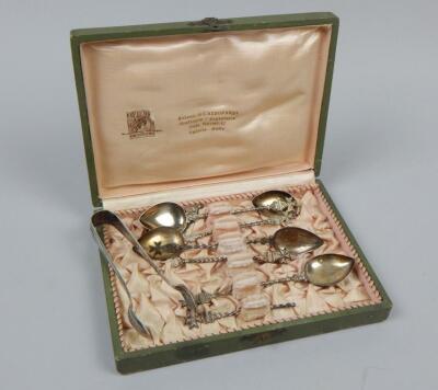 A set of six white metal teaspoons