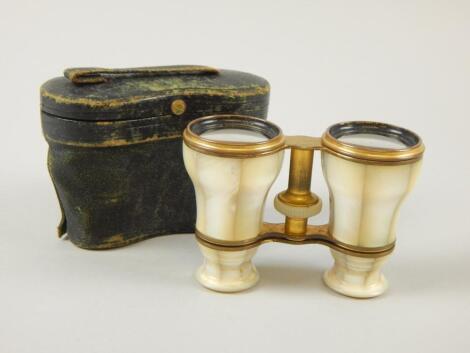 A pair of late 19thC/early 20thC gilt metal and mother of pearl adjustable opera glasses