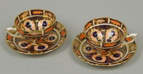 A pair of Royal Crown Derby Imari pattern pedestal cups and saucers