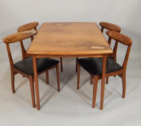 A Retro style Scandinavian influenced teak dining room table and four chairs