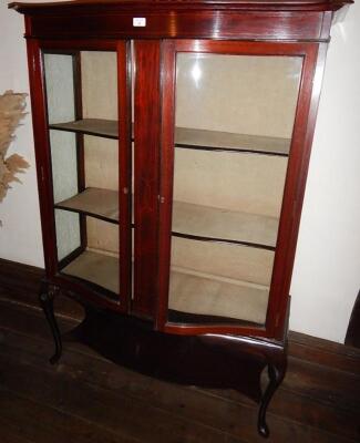 An Edwardian string inlaid mahogany serpentine china cabinet