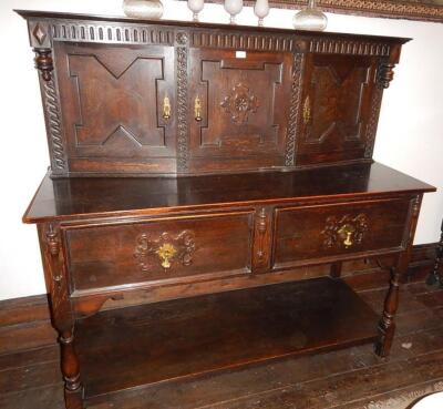 An early 20thC Jacobean style oak serving cabinet