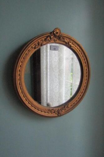 A small circular gilt framed wall mirror