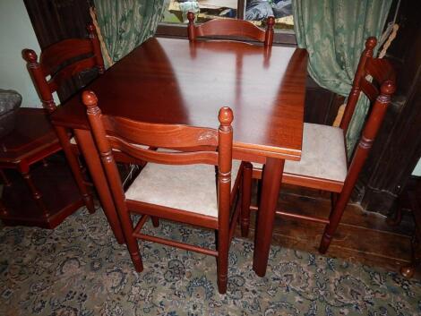 A modern square draw leaf table and set of four chairs.