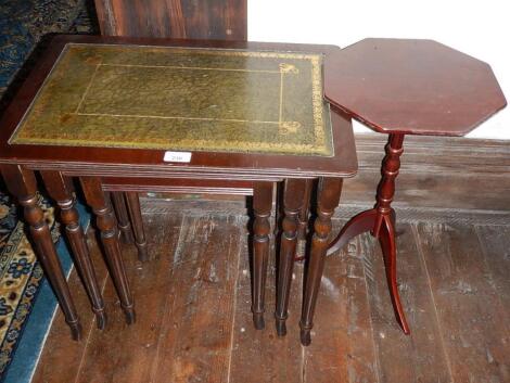 A nest of three reproduction mahogany coffee tables and a tripod table.