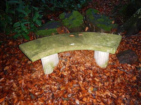 A reconstituted stone garden bench.