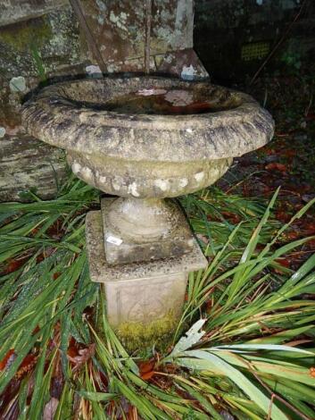 A reconstituted stone garden urn