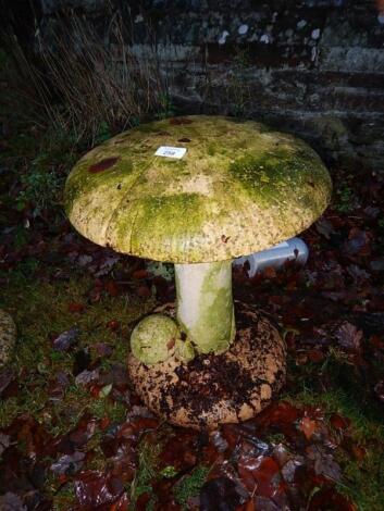 A reconstituted stone mushroom garden ornament