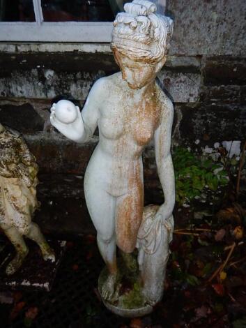 A ornamental garden figure of a semi clad classical female