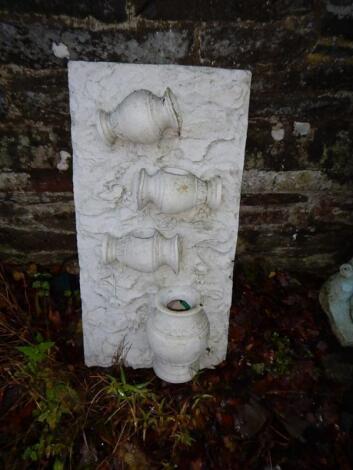 A modern garden fountain plaque.