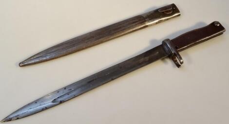 An early 20thC metal bayonet and scabbard