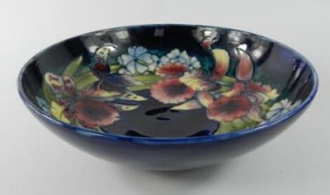 A Moorcroft pottery bowl decorated in the Orchid pattern