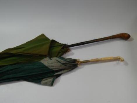 An Edwardian green silk parasol