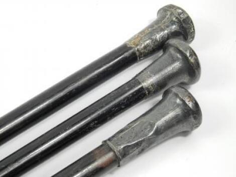 A group of three Victorian ebony and silver topped walking sticks