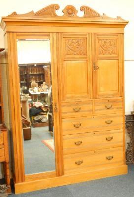 An early 20thC carved oak wardrobe