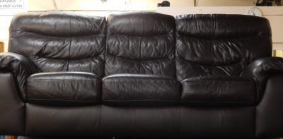 A brown leather three seater sofa