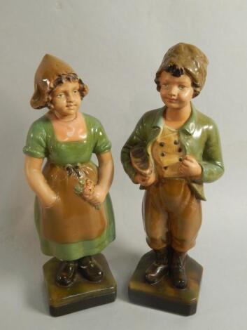 A pair of early 20thC painted plaster figures