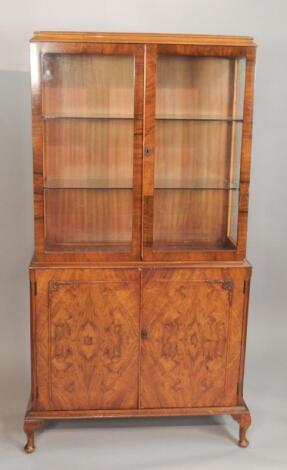 A mid 20thC walnut display cabinet