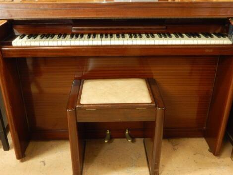 An Eavestaff mini piano in mahogany case