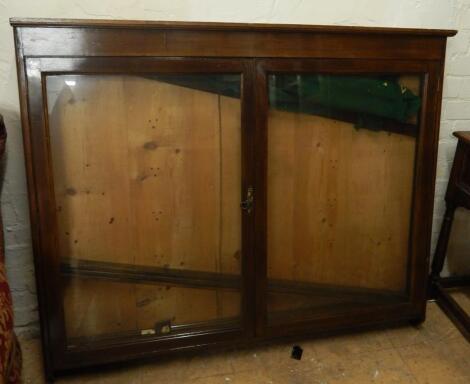 An early 20thC oak wall mounted display cabinet