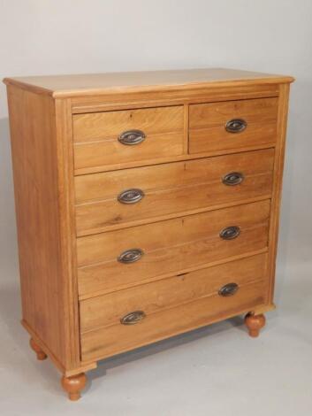 A late Victorian pale walnut chest of drawers