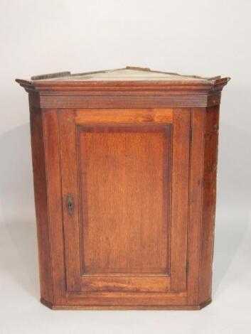 A George III oak and mahogany cross banded corner cabinet