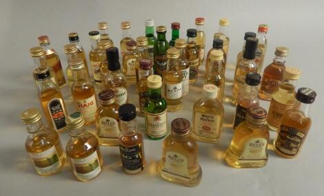 Various miniature bottles of whisky.