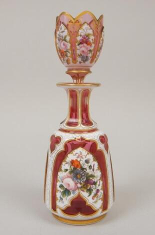 An unusual Bohemian cranberry tinted and white overlay glass spirit decanter