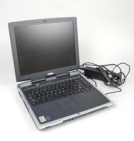 A Toshiba Satellite laptop and adapter.