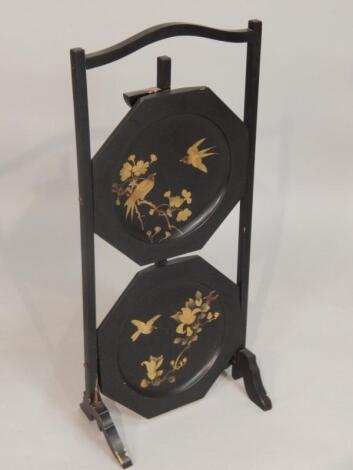 An early 20thC black Japanned two tier cake stand