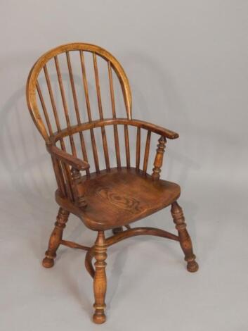 A modern oak child's Windsor chair