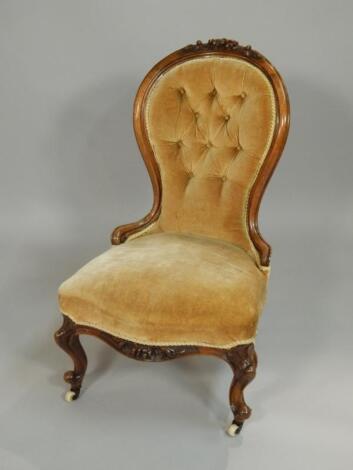 A Victorian walnut nursing chair