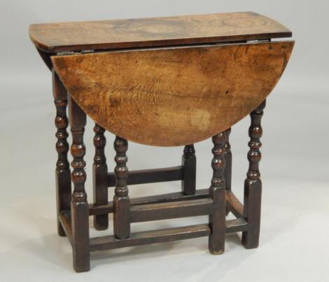 An 18thC oak oval gate leg table