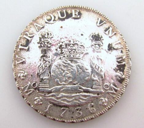 A 1736 Spanish Colonial eight reales coin.