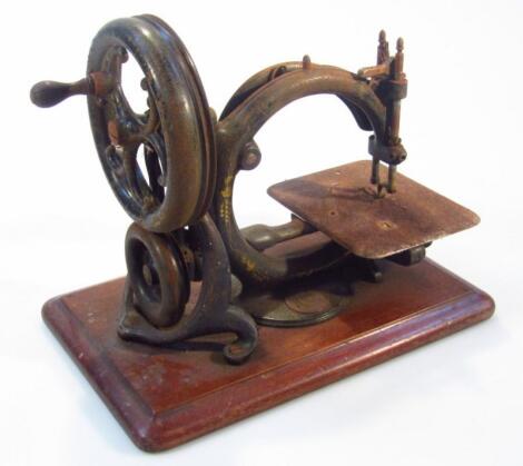 A late 19thC C shaped manual sewing machine