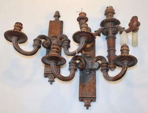 A pair of 19thC carved wooden wall sconces