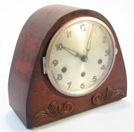 A mid-20thC oak stained mantel clock