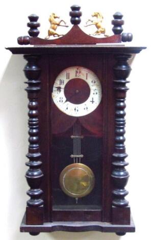 An early 20thC oak stained part Vienna wall clock