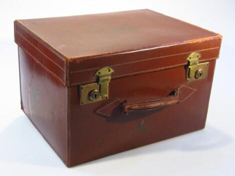 A mid-20thC brown pressed leather travel box