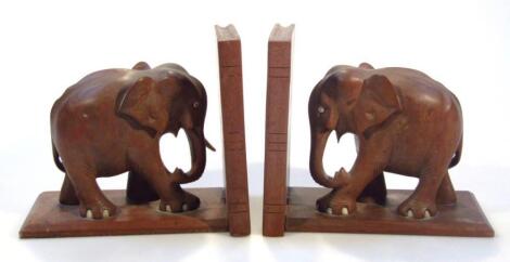 A pair of early 20thC mahogany and hardwood elephant book ends