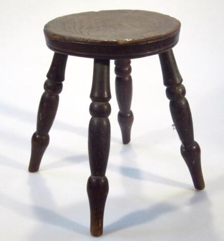 A late 19thC ash and elm four pronged milking stool