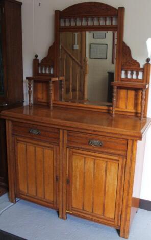 An Edwardian oak mirror back side cabinet