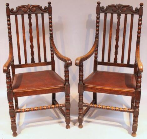 A pair of Edwardian oak carolean style carver chairs