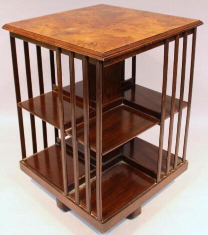 An Edwardian walnut rotating bookcase