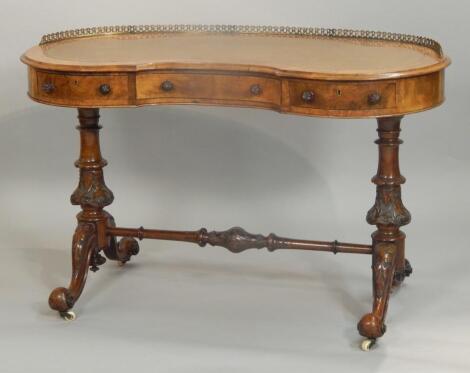 A Victorian walnut and marquetry kidney shaped writing table