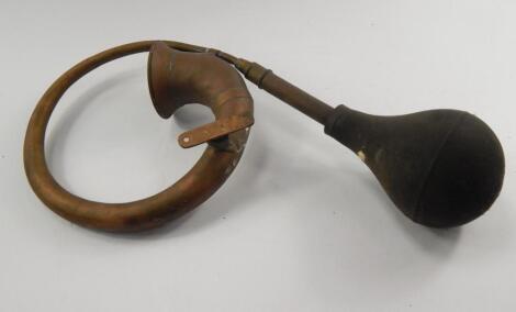 A vintage brass car horn.