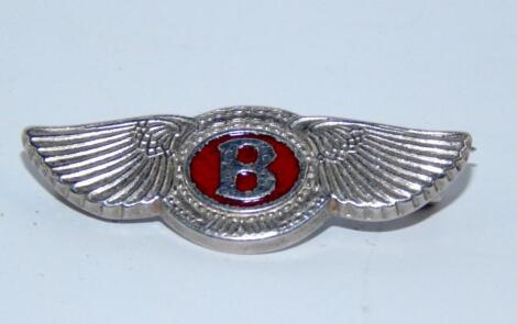 A silver Bentley pin badge