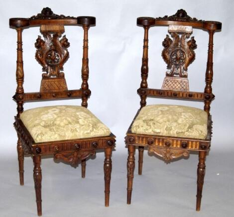 A pair of Continental walnut prie dieu chairs